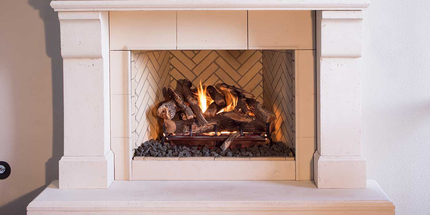 A traditional, white decorative hearth and mantel with a square gas fireplace and rustic, realistic gas log set.