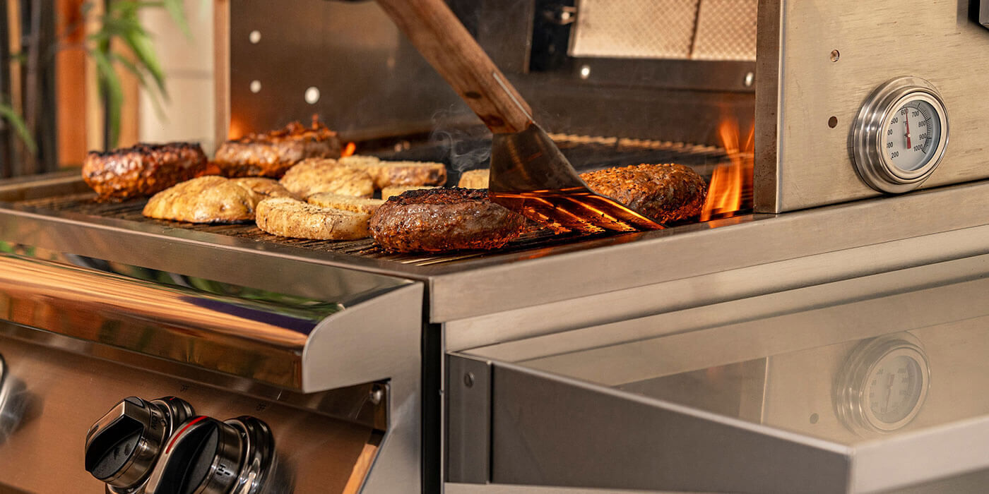 A close-up view of a T-Series gas grill by PGS, which comes with a built-in automatic shutoff timer and a temperature gauge to help you prepare perfectly cooked meals every time.