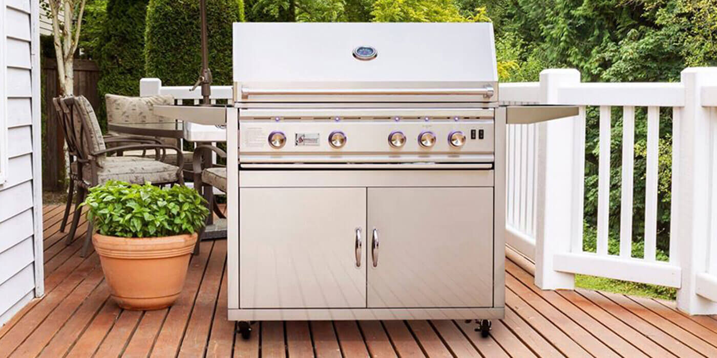 A stainless steel Propane stainless steel gas grill cart on an outdoor wooden deck.