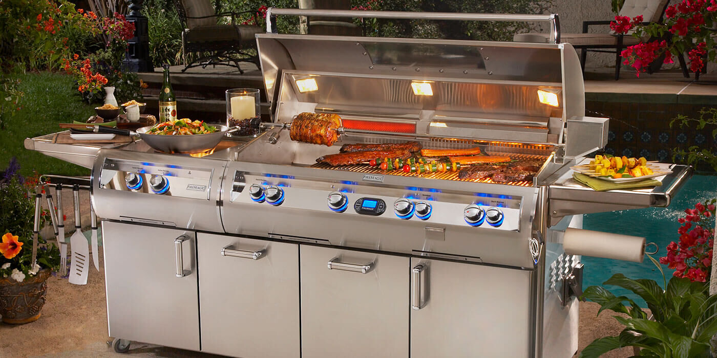 An extra-large, stainless steel Estate grill cart from American Made grills with a massive main cooking surface, two large side shelves, two access doors, and two extra storage drawers for utensils, pots, pans, dishes, and ingredients.