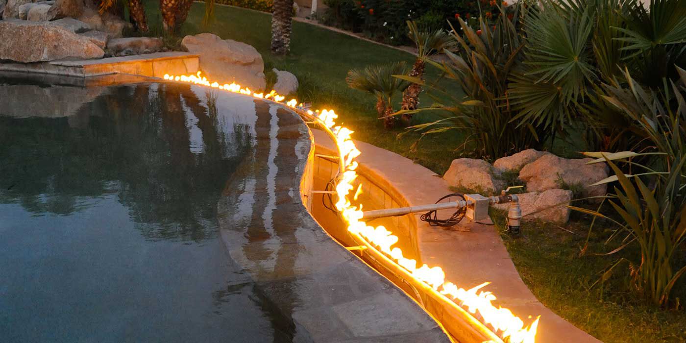 A custom-made tube burner installed around the edge of an outdoor pool.